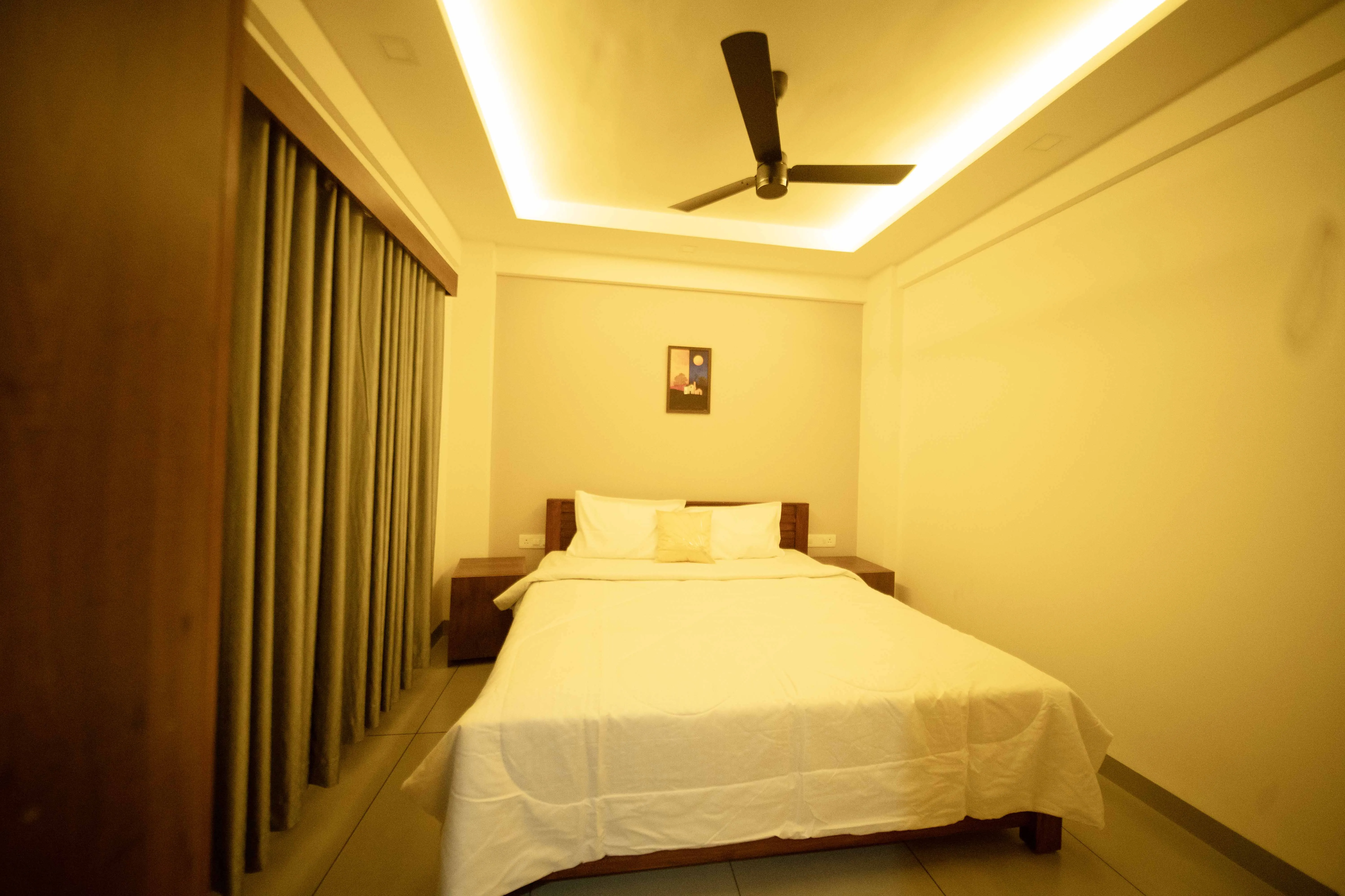 Spezio Apartments bedroom with king bed Perinthalmanna